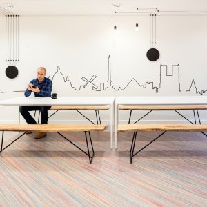 Home office ze stołem Nuur od Arper i laptopem